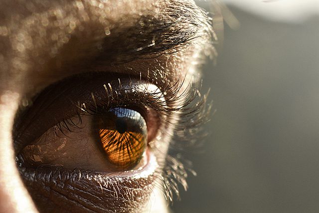 Closeup of a man's eye with sun shining on it